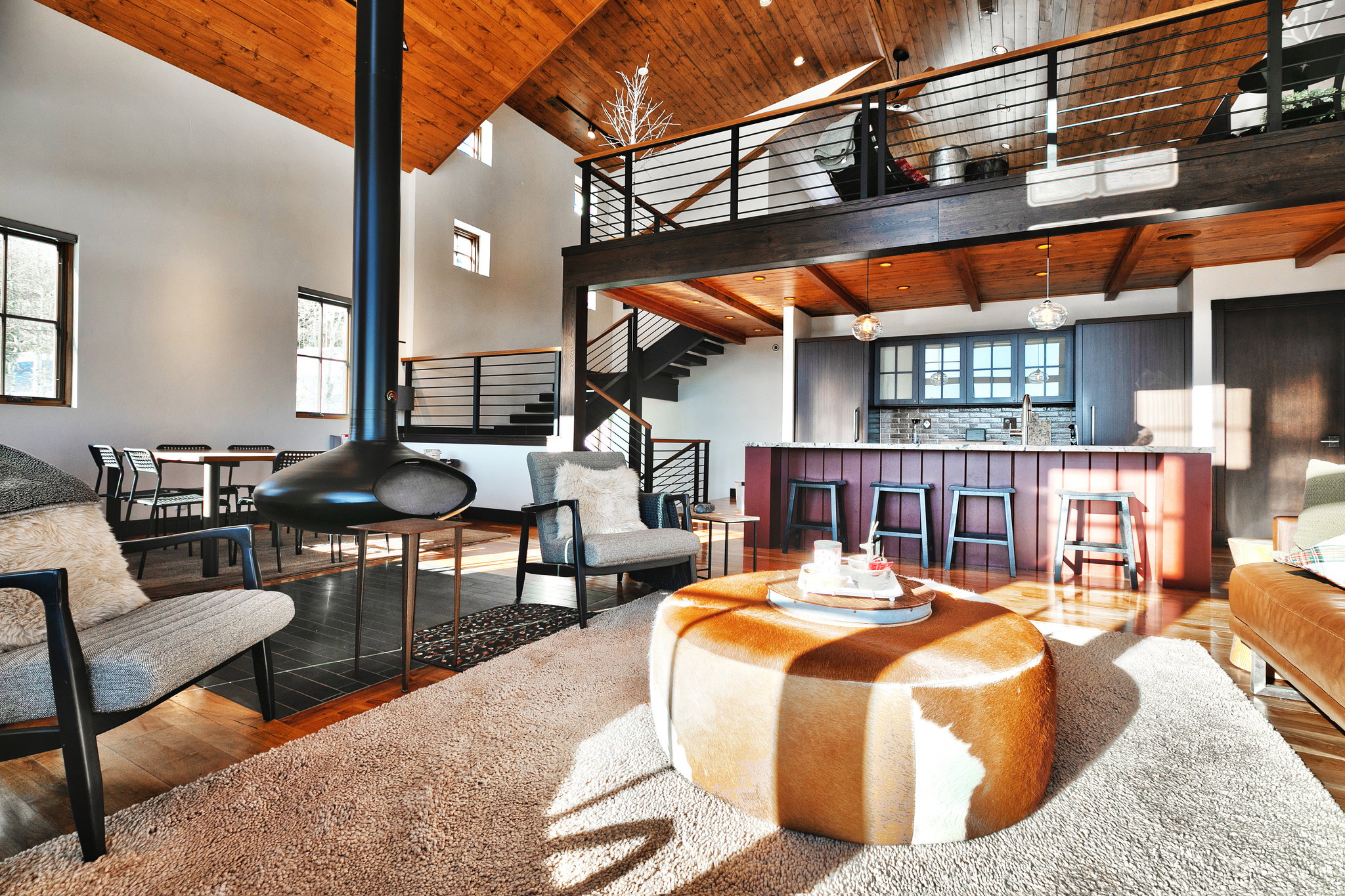 Living room featuring a vaulted wood ceiling, hardwood / wood-style floors, and healthy amount of natural light