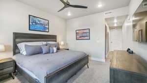 Bedroom with light carpet, ceiling fan, and recessed lighting