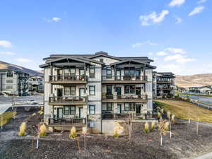 Rear view of house featuring a mountain view