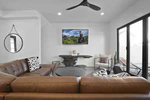 Living area with a ceiling fan and recessed lighting
