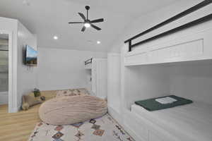 Bedroom with light wood-style floors, vaulted ceiling, ceiling fan, and recessed lighting
