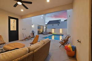 View of pool with patio surround, area for grilling, and outdoor furniture