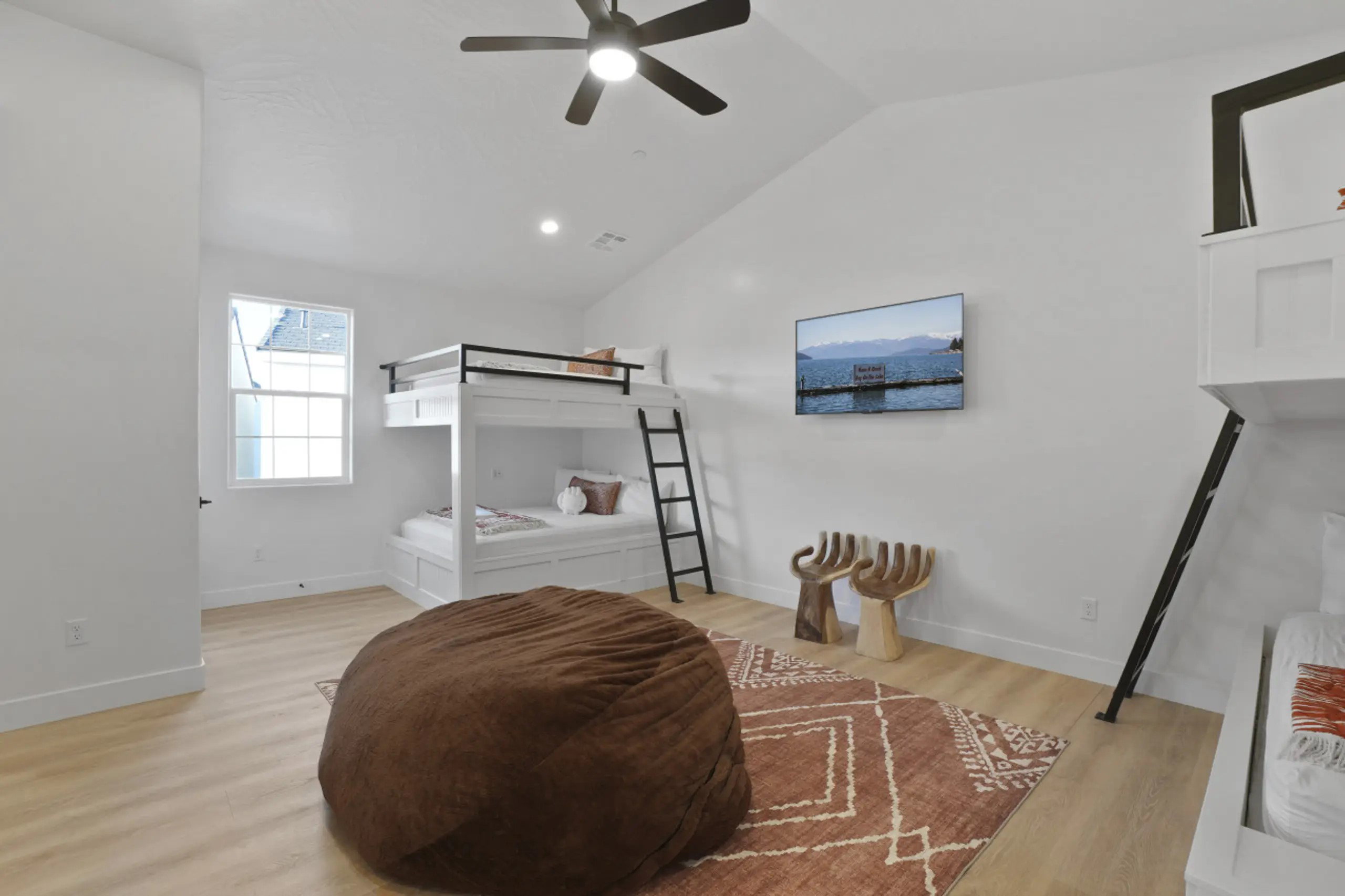 Bedroom with light wood-type flooring, lofted ceiling, ceiling fan, and recessed lighting