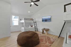 Bedroom with light wood-type flooring, lofted ceiling, ceiling fan, and recessed lighting