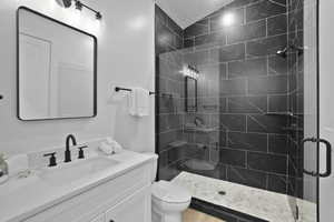 Full bath with a stall shower and vanity