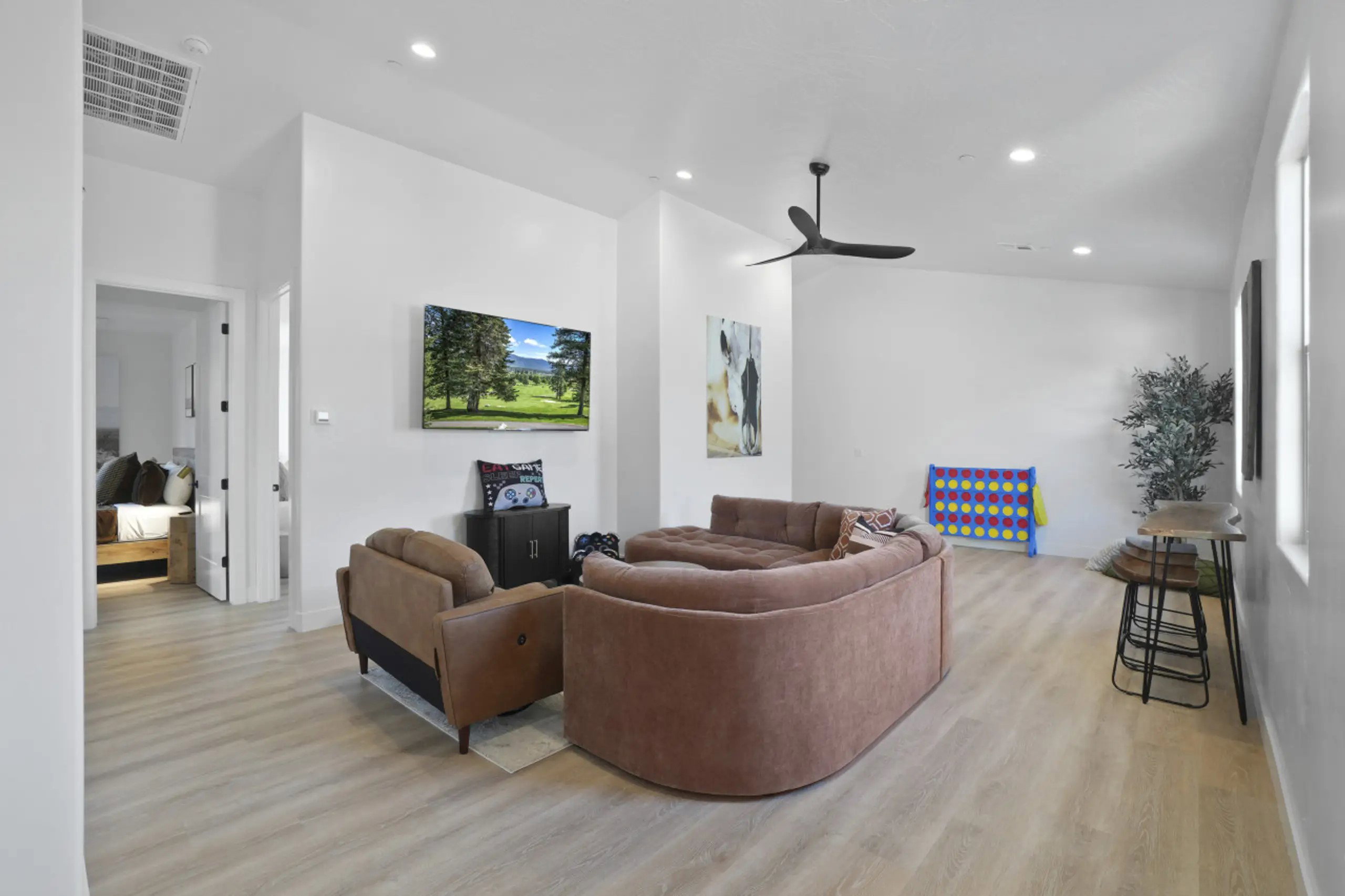 Living area featuring light wood-type flooring, recessed lighting, and a ceiling fan