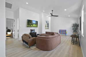 Living area featuring light wood-type flooring, recessed lighting, and a ceiling fan