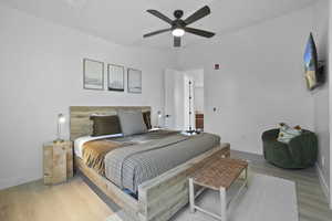 Bedroom featuring wood finished floors and a ceiling fan