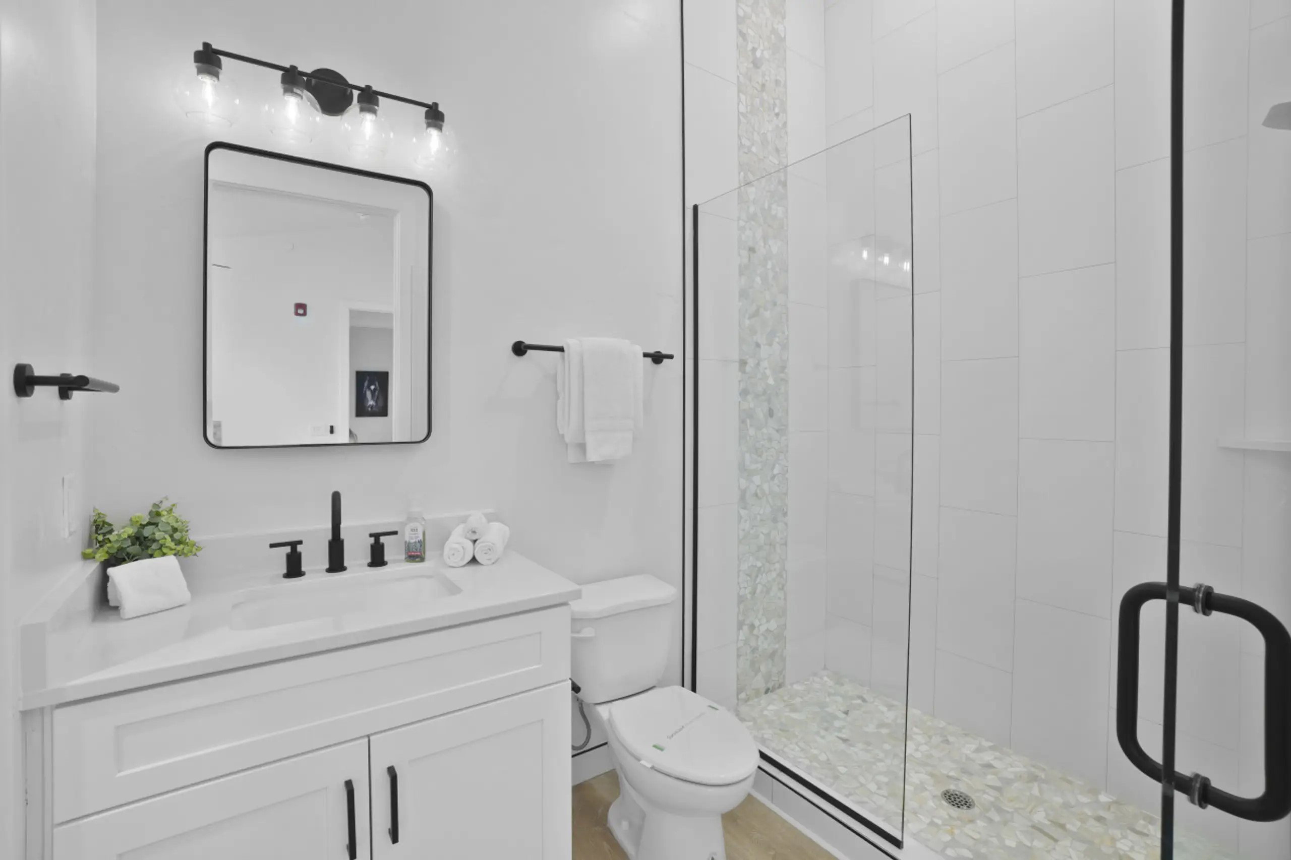 Bathroom featuring vanity and a shower stall