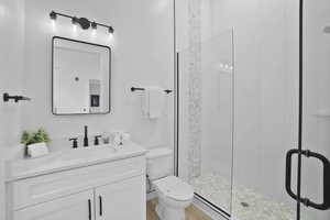 Bathroom featuring vanity and a shower stall