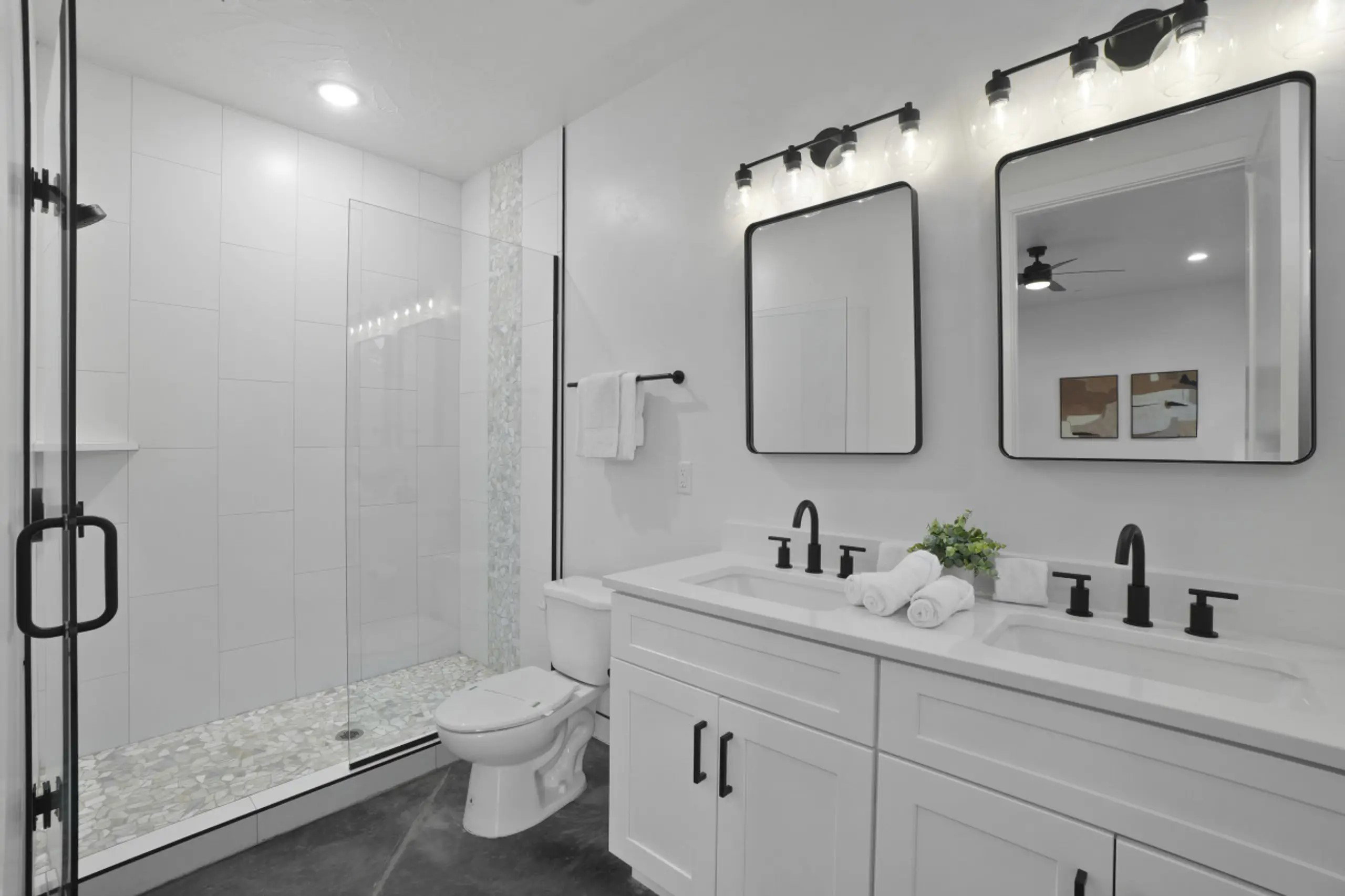 Full bathroom with a shower stall, double vanity, and recessed lighting