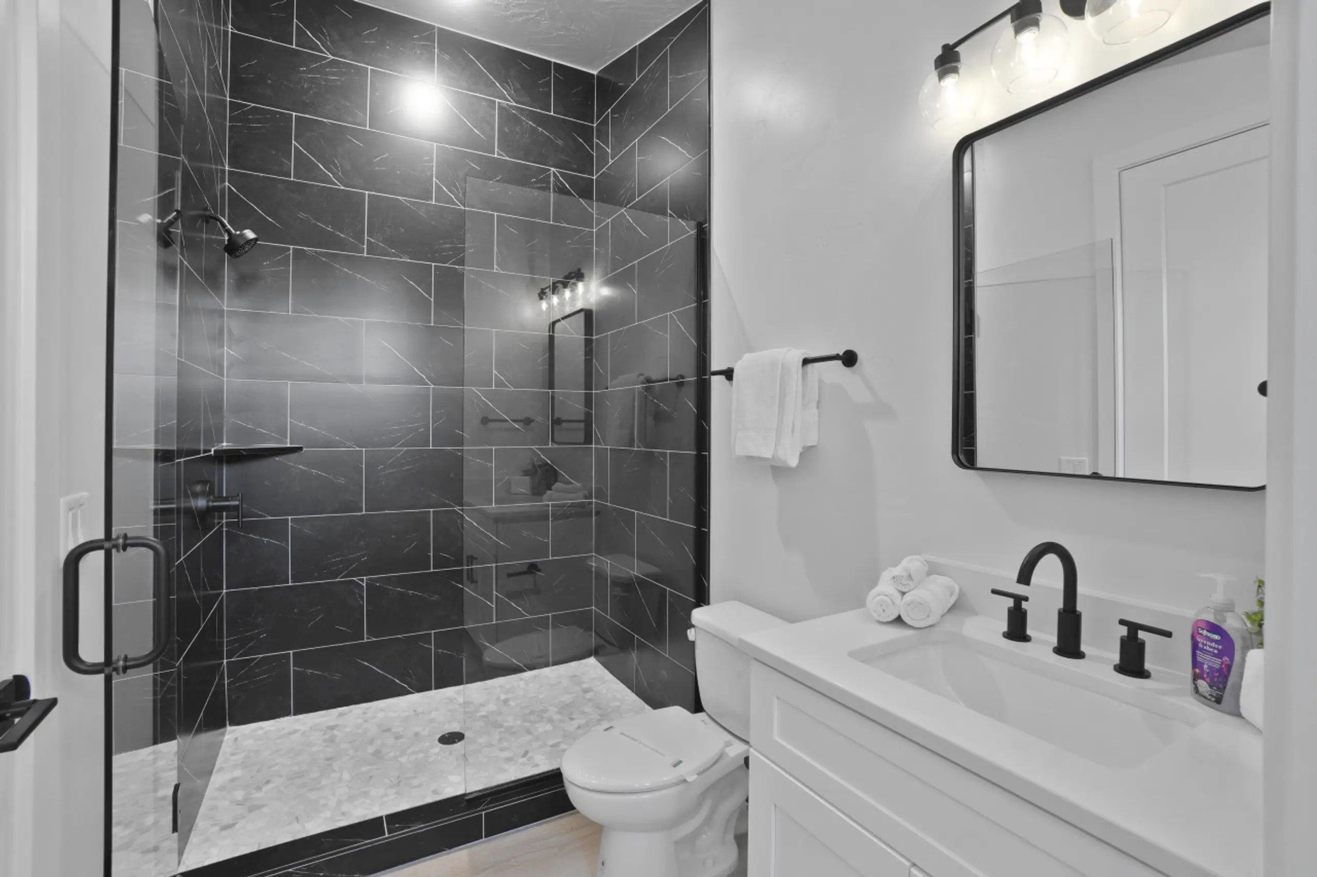 Bathroom featuring a shower stall and vanity