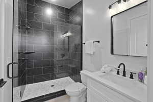 Bathroom featuring a shower stall and vanity