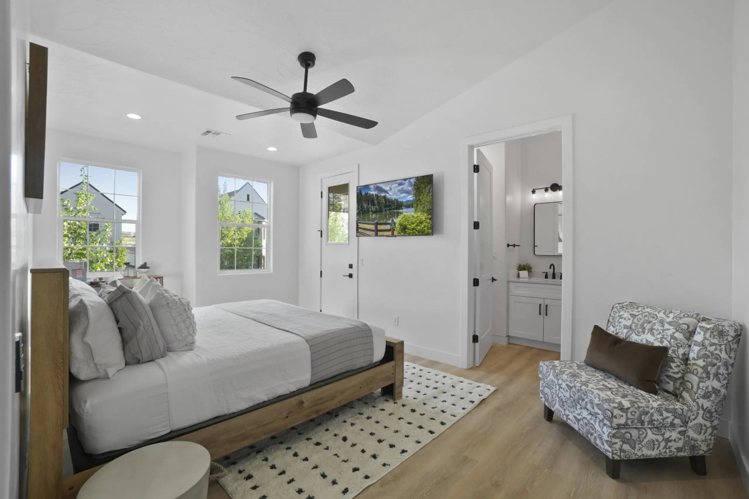 Bedroom with multiple windows, vaulted ceiling, light wood finished floors, ceiling fan, and recessed lighting