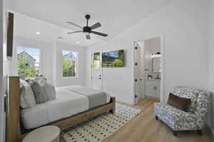 Bedroom with multiple windows, vaulted ceiling, light wood finished floors, ceiling fan, and recessed lighting