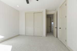 Unfurnished bedroom with light colored carpet, a closet, recessed lighting, and ceiling fan