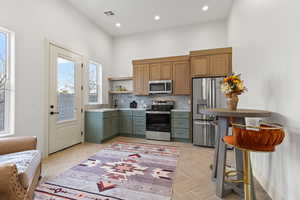 Kitchen featuring stainless steel appliances, open shelves, tasteful backsplash, parquet floors, and recessed lighting