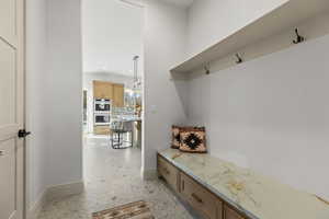 Mudroom with baseboards and recessed lighting