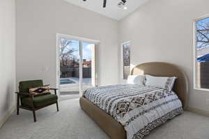Bedroom featuring access to exterior, light colored carpet, and ceiling fan