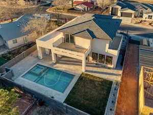 Relaxing pool / spa with a patio area, a fenced backyard, and a residential view