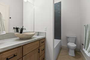 Full bath featuring vanity and toilet