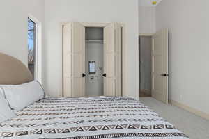 Bedroom featuring light carpet and a closet