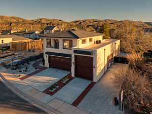 Mediterranean / spanish-style house with stucco siding, concrete driveway, an attached garage, and a mountain view