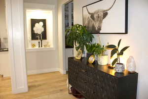 Hallway featuring light wood finished floors and baseboards