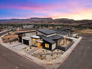 View of front of home featuring stucco siding, a mountain view, and stone siding