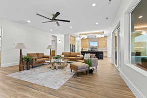 Living area with ceiling fan, wood finish floors, and recessed lighting
