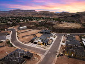 Aerial overview of property's location with nearby suburban area and mountains