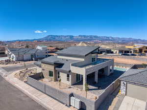 View of front facade with a residential view, a fenced front yard, stucco siding, and a mountain view