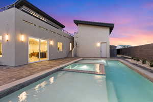 Integrated pool / spa featuring a patio area and a fenced backyard