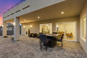 Patio terrace at dusk with a patio and an outdoor living / dining area