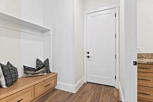 Mudroom with dark wood-style flooring and baseboards