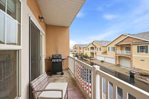 Balcony featuring grilling area and a residential view