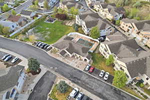 Aerial view of property and surrounding area featuring nearby suburban area