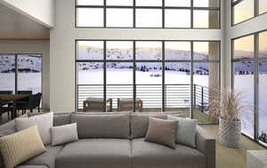 Living area featuring a mountain view, a high ceiling, and hardwood / wood-style flooring