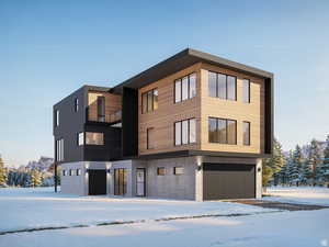 Snow covered building featuring a garage
