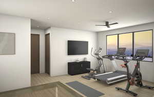 Exercise area featuring a ceiling fan, light wood-type flooring, and recessed lighting