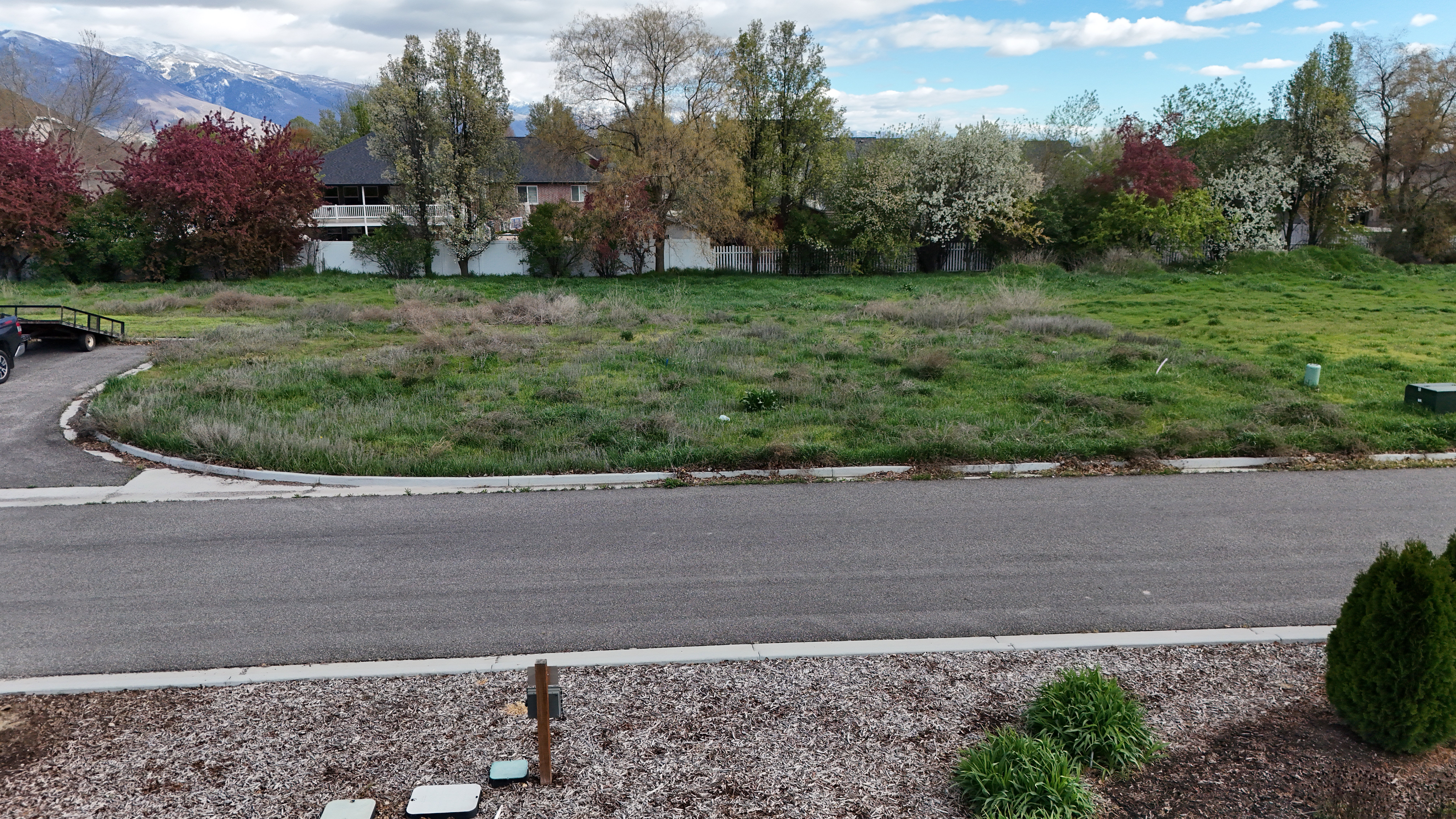View of asphalt street with curbs