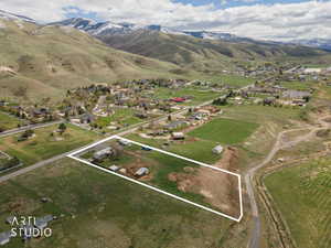 Aerial perspective of suburban area with property boundaries highlighted and a mountain backdrop
