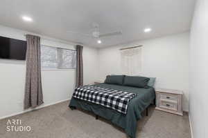 Bedroom featuring light colored carpet, a ceiling fan, and recessed lighting