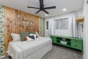 Bedroom with carpet flooring, wallpapered walls, ceiling fan, a textured ceiling, and recessed lighting
