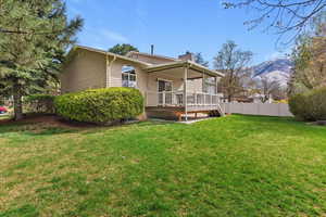 Rear view of property featuring a chimney and a mountain view