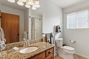 Full bath with vanity and a shower with shower curtain