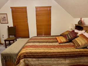 Carpeted bedroom featuring baseboards