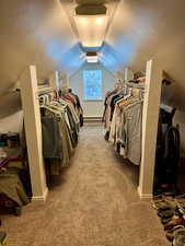 Walk in closet with carpet floors