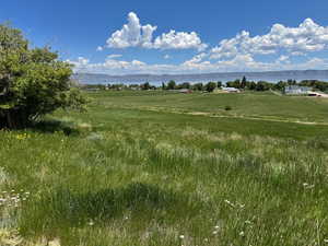 View of pasture land featuring rural landscape and mountains