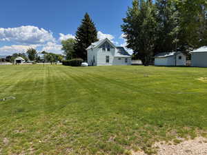 View of grassy yard with RV hookups
